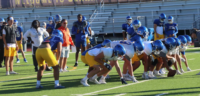 Serra coach Patrick Walsh (in orange) overseas an early August practice. Photo: John Murphy